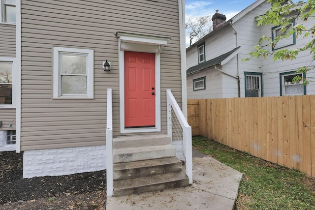 entrance to property with fence and a chimney