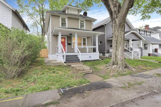 traditional style home with fence and covered porch