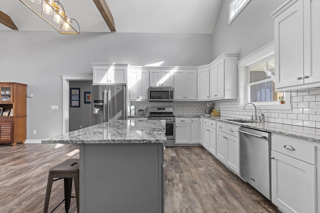 10695 State Route 93 N, Logan, OH 43138 - kitchen with a kitchen island, appliances with stainless steel finishes, tasteful backsplash, a sink, and high vaulted ceiling
