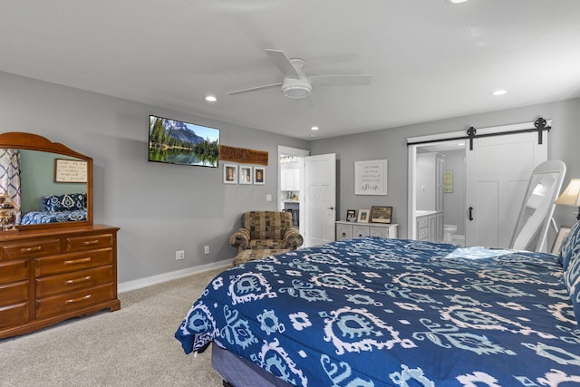 10695 State Route 93 N, Logan, OH 43138 - carpeted bedroom featuring baseboards, ensuite bathroom, recessed lighting, a barn door, and a ceiling fan