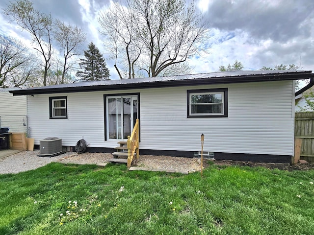 4518 Broadhurst Dr, Columbus, OH 43213 - rear view of house featuring entry steps, central AC unit, a yard, and metal roof