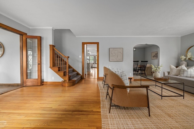 1920 Chatfield Rd, Columbus, OH 43221 - living room with wood finished floors, arched walkways, stairs, baseboards, and crown molding