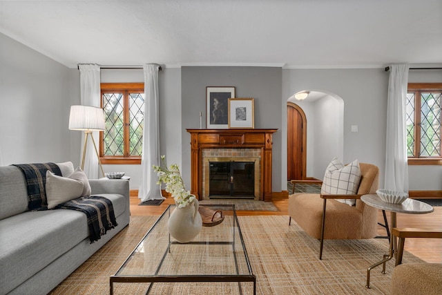 1920 Chatfield Rd, Columbus, OH 43221 - living area with arched walkways, wood finished floors, baseboards, ornamental molding, and a glass covered fireplace