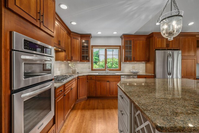 1920 Chatfield Rd, Columbus, OH 43221 - kitchen with stainless steel appliances, a sink, brown cabinetry, backsplash, and recessed lighting