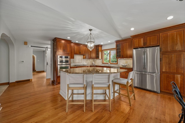 1920 Chatfield Rd, Columbus, OH 43221 - kitchen with appliances with stainless steel finishes, arched walkways, tasteful backsplash, a kitchen bar, and glass insert cabinets