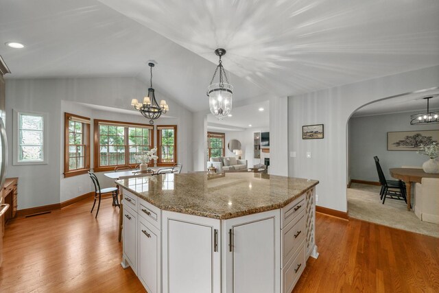 1920 Chatfield Rd, Columbus, OH 43221 - kitchen featuring a chandelier, arched walkways, white cabinetry, baseboards, and lofted ceiling