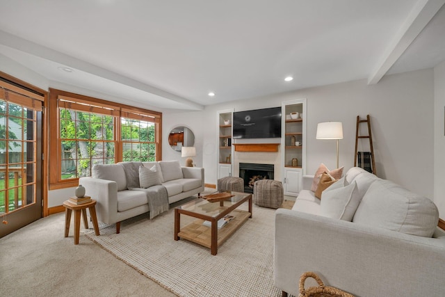 1920 Chatfield Rd, Columbus, OH 43221 - living room featuring a fireplace, recessed lighting, light colored carpet, built in shelves, and baseboards