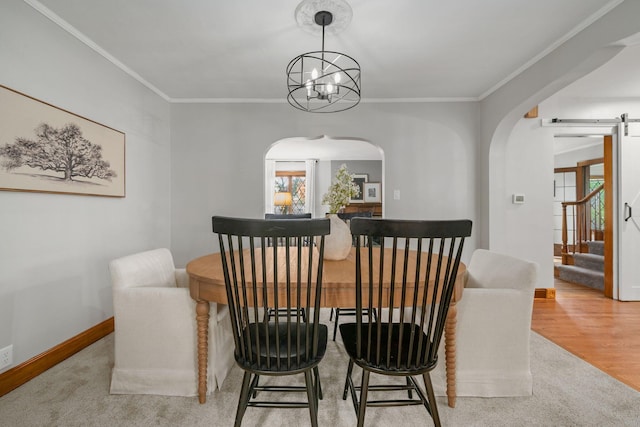 1920 Chatfield Rd, Columbus, OH 43221 - dining space featuring arched walkways, baseboards, a barn door, ornamental molding, and a chandelier