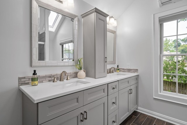 1920 Chatfield Rd, Columbus, OH 43221 - full bathroom featuring backsplash, a skylight, double vanity, plenty of natural light, and lofted ceiling