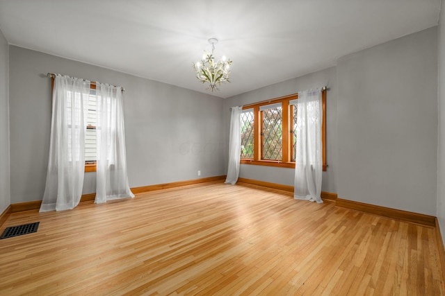 1920 Chatfield Rd, Columbus, OH 43221 - unfurnished room featuring a chandelier, light wood-style floors, and baseboards