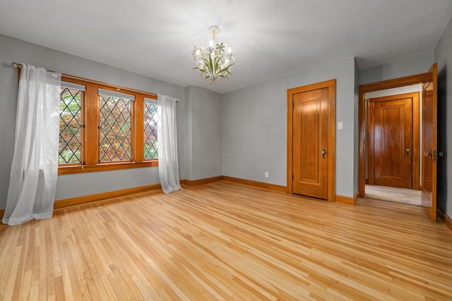 1920 Chatfield Rd, Columbus, OH 43221 - spare room with light wood finished floors, a chandelier, and baseboards