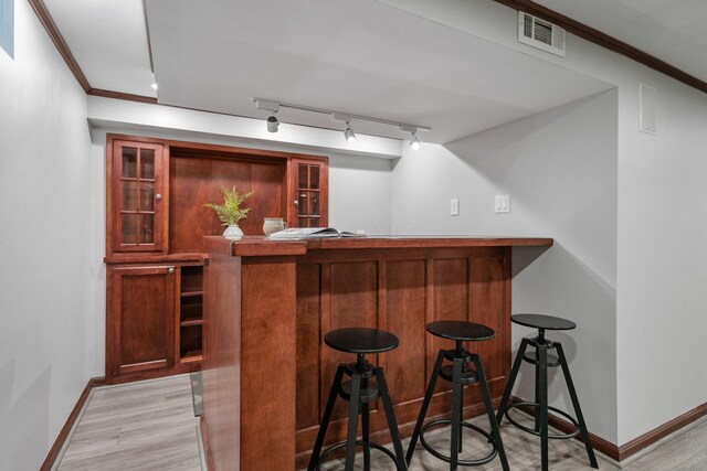 1920 Chatfield Rd, Columbus, OH 43221 - indoor bar with baseboards, light wood-style floors, ornamental molding, and track lighting