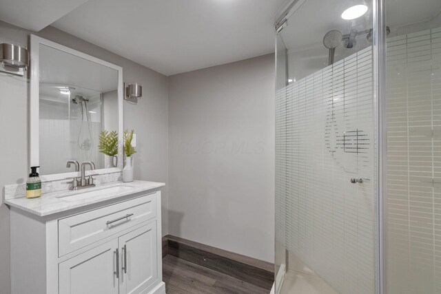 1920 Chatfield Rd, Columbus, OH 43221 - bathroom featuring wood finished floors, a stall shower, vanity, and baseboards