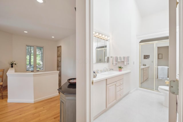 full bath with vanity, toilet, recessed lighting, wood finished floors, and a stall shower