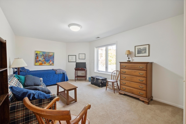 bedroom with light colored carpet and baseboards