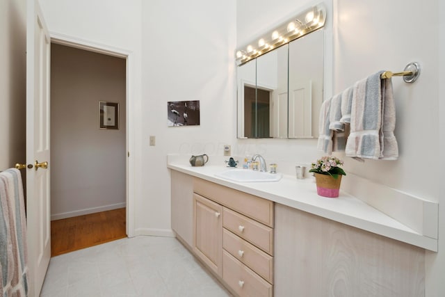 bathroom with vanity and baseboards
