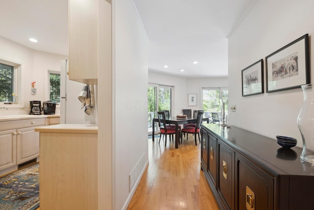 hallway featuring light wood-style floors, recessed lighting, and visible vents