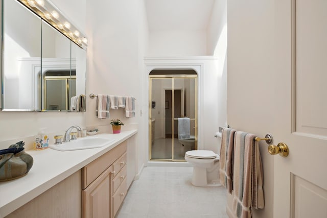 bathroom featuring vanity, tile patterned flooring, a stall shower, and toilet