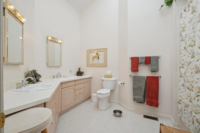 bathroom with a sink, baseboards, toilet, and visible vents