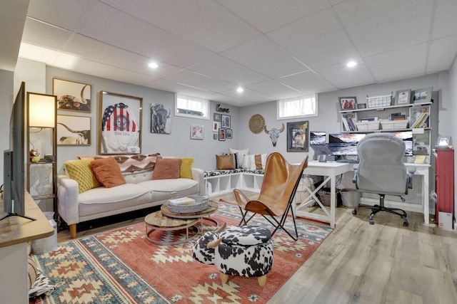 living room featuring a drop ceiling and wood finished floors