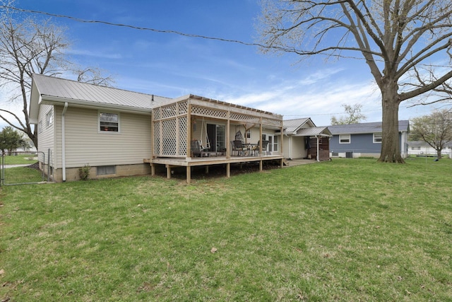rear view of house with a lawn, a wooden deck, a pergola, and metal roof