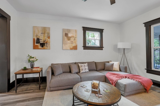 living room with ceiling fan and wood finished floors