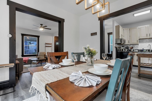 dining room with ceiling fan and wood finished floors