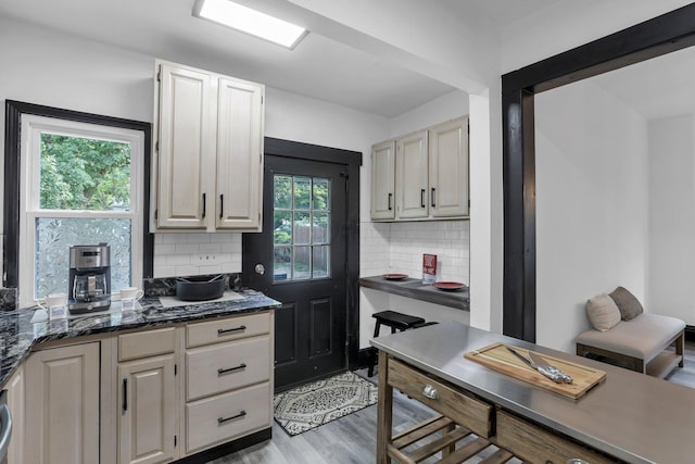 kitchen with tasteful backsplash and light wood-type flooring