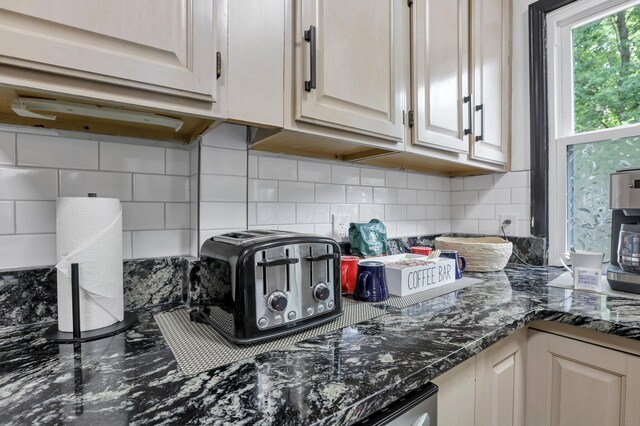kitchen with a toaster and tasteful backsplash