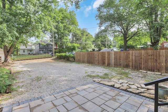 view of yard featuring fence and a patio area