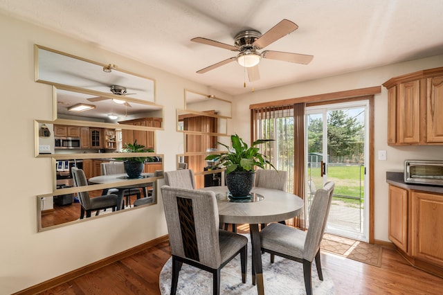 6065 Batavia Rd, Westerville, OH 43081 - dining area featuring baseboards, light wood-style flooring, and ceiling fan
