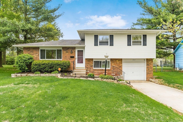 6065 Batavia Rd, Westerville, OH 43081 - tri-level home with an attached garage, concrete driveway, a front lawn, and brick siding