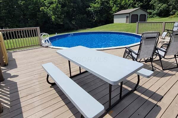 16900 Thompson Ridge Rd, Laurelville, OH 43135 - outdoor pool featuring a yard, a deck, and an outdoor structure