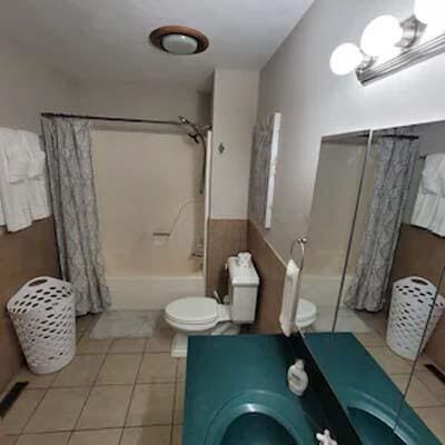 16900 Thompson Ridge Rd, Laurelville, OH 43135 - full bathroom featuring toilet, shower / tub combo with curtain, and tile patterned flooring