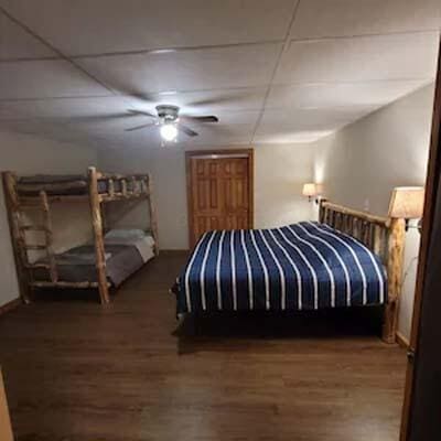 16900 Thompson Ridge Rd, Laurelville, OH 43135 - bedroom with a ceiling fan, a paneled ceiling, and wood finished floors