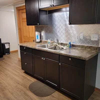 16900 Thompson Ridge Rd, Laurelville, OH 43135 - kitchen with backsplash, baseboards, light wood-style flooring, and a sink