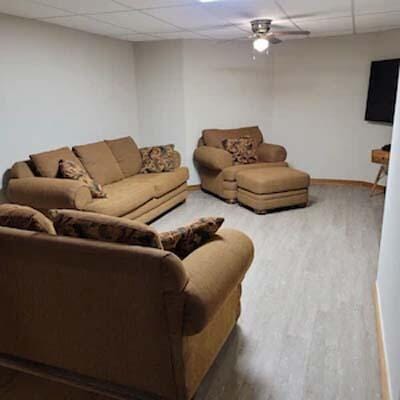 16900 Thompson Ridge Rd, Laurelville, OH 43135 - living room featuring a paneled ceiling, baseboards, and wood finished floors