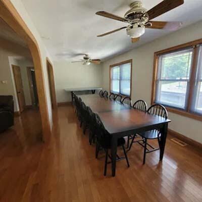 16900 Thompson Ridge Rd, Laurelville, OH 43135 - dining room with arched walkways, baseboards, ceiling fan, and wood finished floors