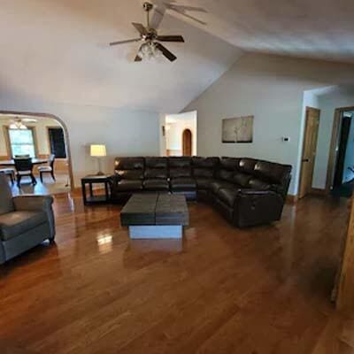 16900 Thompson Ridge Rd, Laurelville, OH 43135 - living area featuring arched walkways, wood finished floors, ceiling fan, and vaulted ceiling