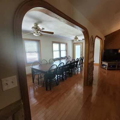 16900 Thompson Ridge Rd, Laurelville, OH 43135 - dining space featuring wood finished floors, ceiling fan, and arched walkways