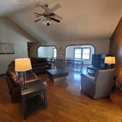 16900 Thompson Ridge Rd, Laurelville, OH 43135 - living room featuring arched walkways, wood finished floors, ceiling fan, and vaulted ceiling