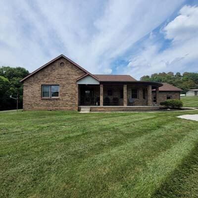 16900 Thompson Ridge Rd, Laurelville, OH 43135 - rear view of property with brick siding and a lawn