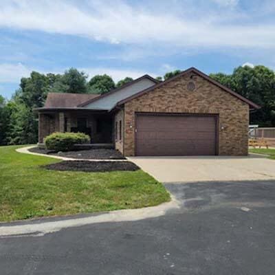 16900 Thompson Ridge Rd, Laurelville, OH 43135 - ranch-style home with a front lawn, driveway, and an attached garage