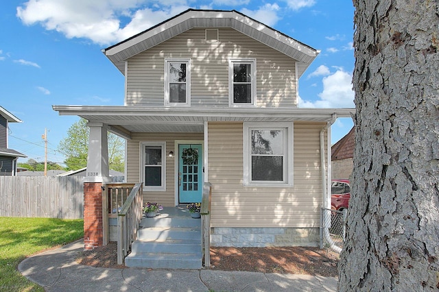 view of front of house with fence and a porch