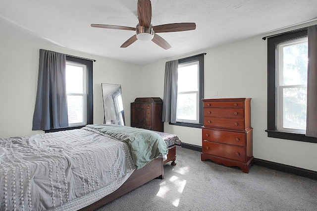 bedroom featuring carpet floors, baseboards, and ceiling fan