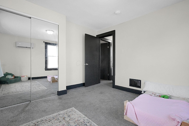carpeted bedroom featuring baseboards, a wall mounted AC, visible vents, and a closet