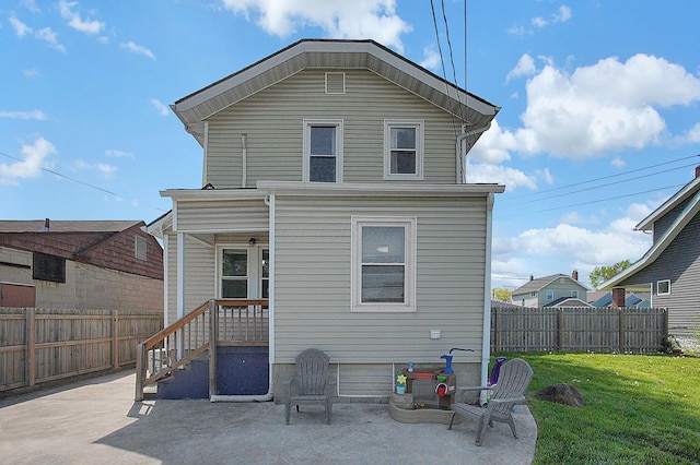 back of house with a patio, fence, and a yard