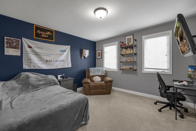carpeted bedroom with baseboards and a textured ceiling