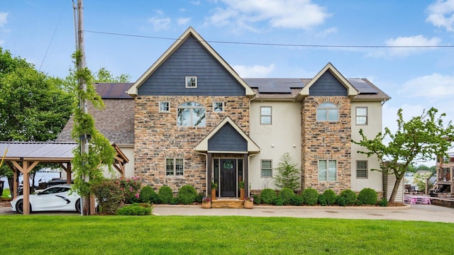 11290 Honeycreek Rd NW, Thornville, OH 43076 - view of front of property with stone siding, a front lawn, roof mounted solar panels, stucco siding, and a carport