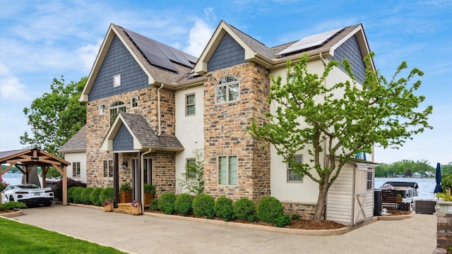 11290 Honeycreek Rd NW, Thornville, OH 43076 - view of front facade featuring stone siding, solar panels, and a gazebo
